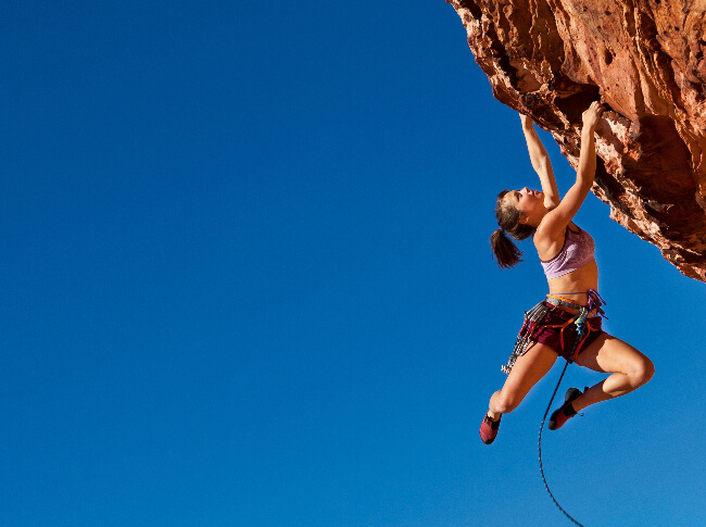 Woman rock climbing - overcoming obstacles