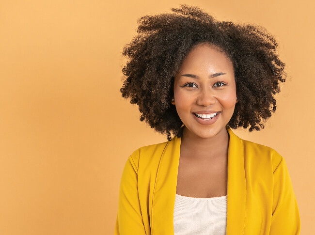 A woman smiling, looking at the camera