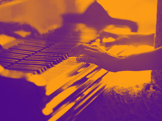 A photo image of someone playing a piano.