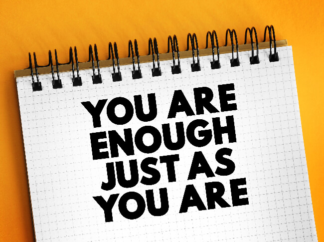 A writing pad that reads, "You are Enough Just as You ARe."