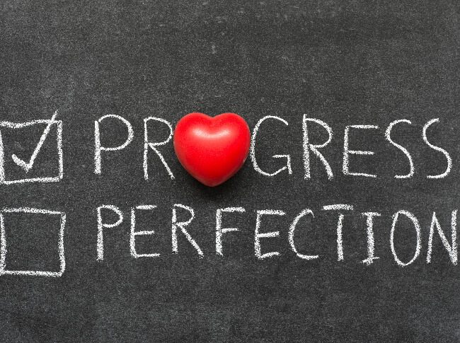  A white board with two options one checkbox for progress (and it's checked) and th other one with perfection (not checked)