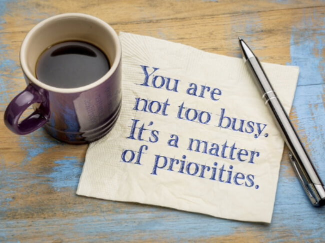 A cup of copy, a napkin that reads, "You are not too busy. It's a matter of prioritites.