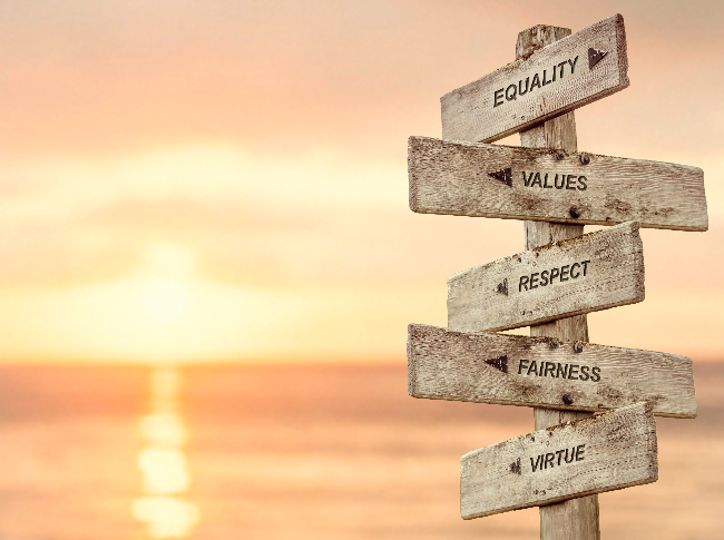 Sign with a sea side sunrise or set. The sign has different values and represents how a life purpose coach can help