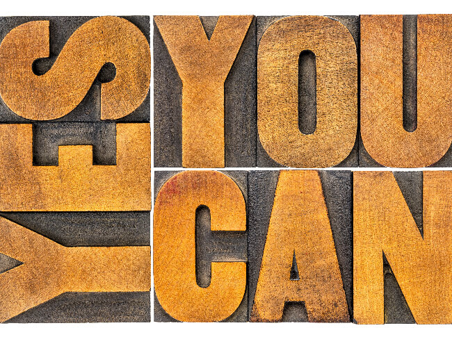 Message about Neuro-Linguistic Programming (NLP) Supposition - a wood design that spells Yes You Can
