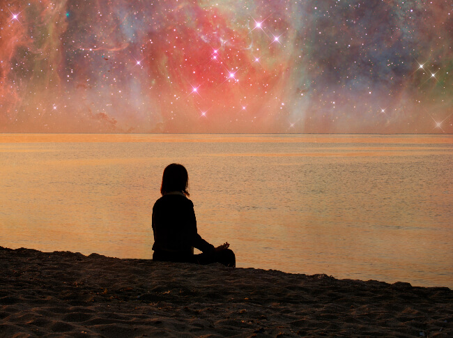 inspirational photo of someone meditating while sitting in front of a body of water.